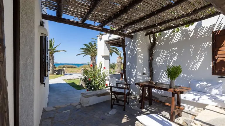 A pergola shaded veranda at one of the studios with a sea view