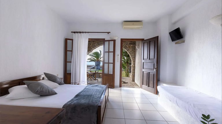 interior of a studio witha double bed and a sofa 