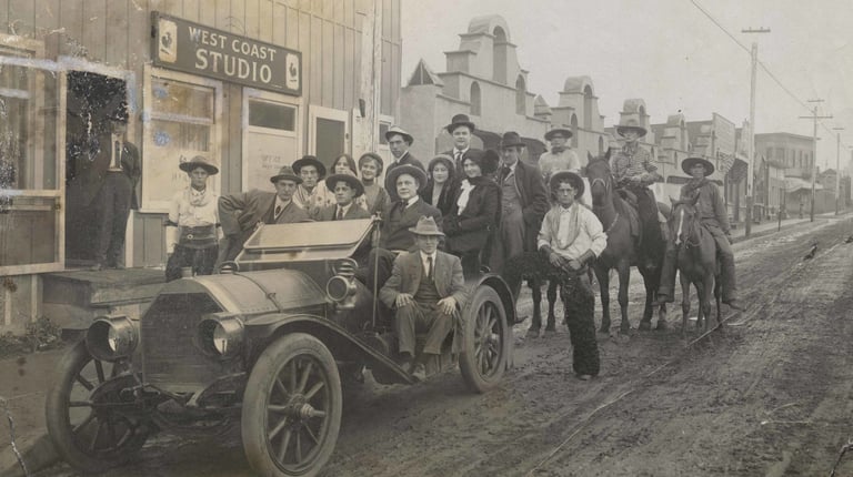 A group portrait of players, crew, and executives in front of Pathé Studios on Allesandro Street 