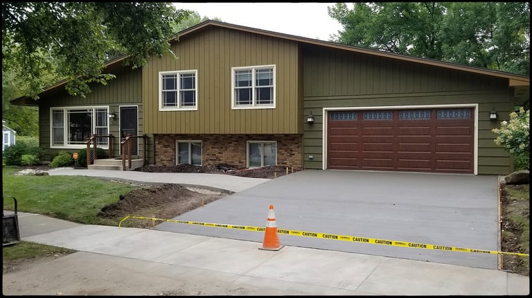 Concrete driveway and concrete sidewalk addition.