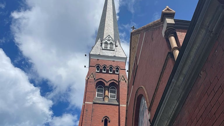 a church with a steeple tower in the background