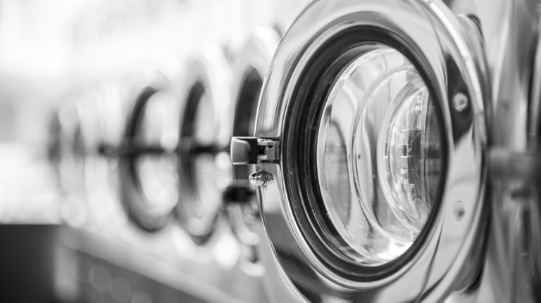 a bunch of laundry machines in a row