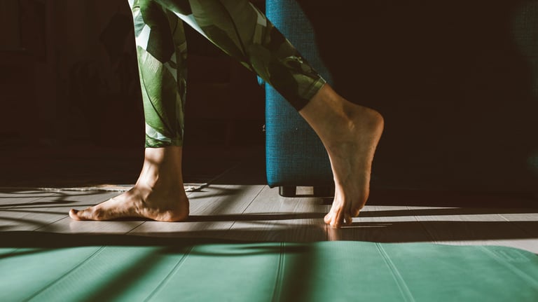 a person standing on a mat with their feet on a mat
