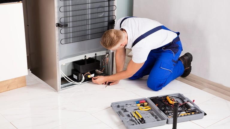 a technician repairing a compressor of a refrigerator