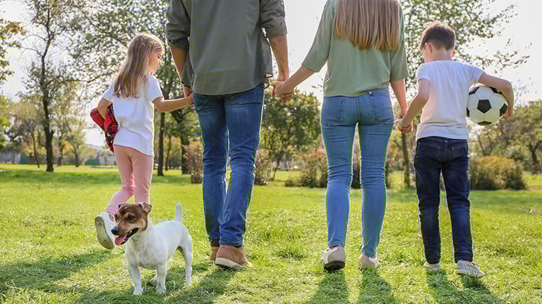 a family of three children playing soccer in a field