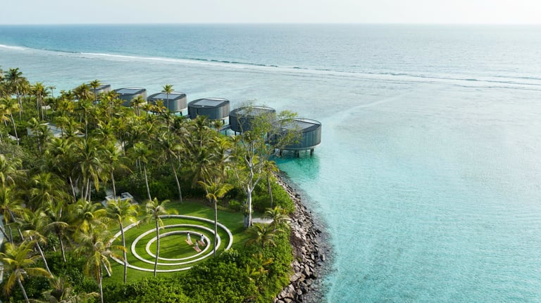 a circular shaped object in the middle of a body of water, The Ritz Carlton Maldives