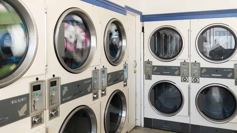 commercial laundry room with coin operated washers and dryers
