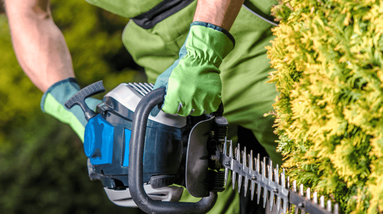 a man in a green shirt is holding a chainsawl