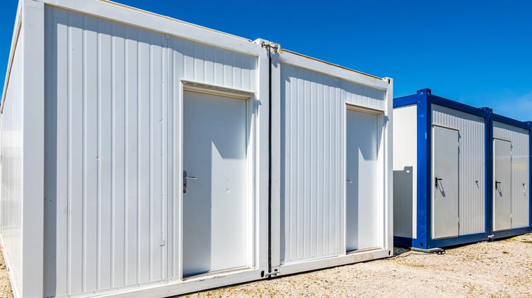 a group of three portable toilets in a desert Morocco 