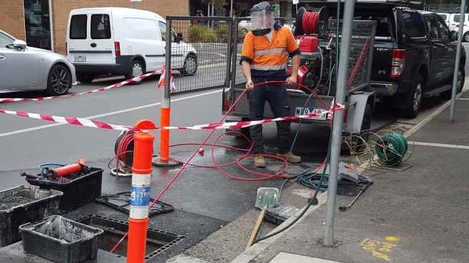 plumber unblocking stormwater pipes