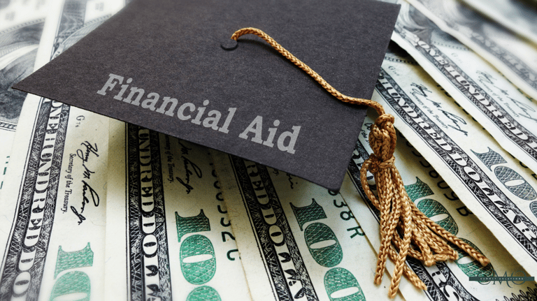 graduation cap labeled Financial Aid laying on $100 bills