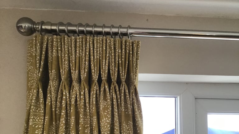 Curtains with stitched triple pleats in a yellow fabric chosen from one of my sample books.