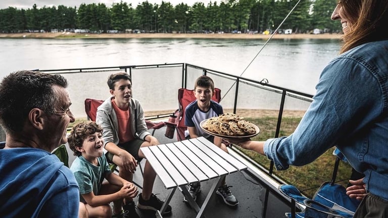 a family eating cookies on an RV deck