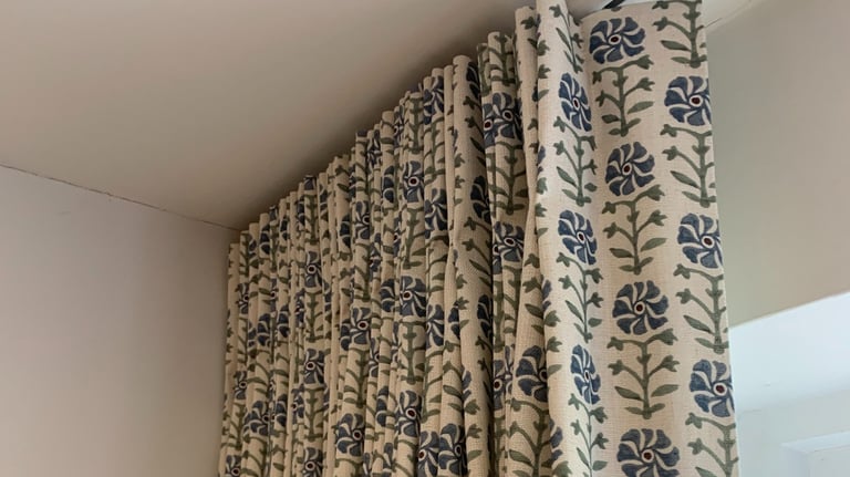 curtain with stitched single pleats hanging on a ceiling track