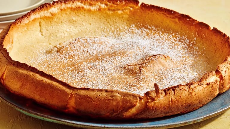 Dutch baby puffed pancake on a blue plate