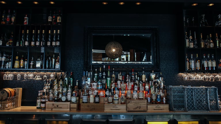 a bar with a lot of bottles of alcohol