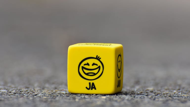a yellow dice game dicer with a smiley face