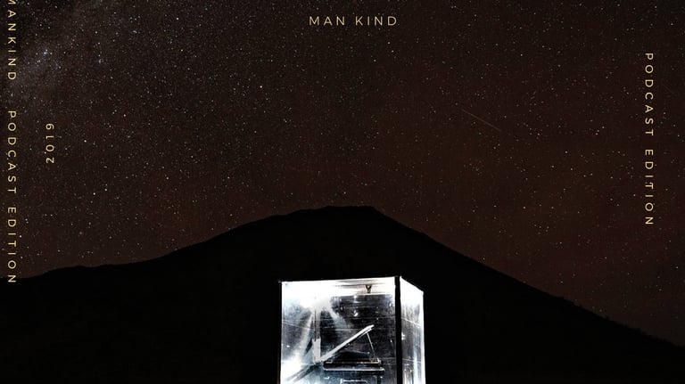 a man in a cube playing a grand piano in front of a mountain