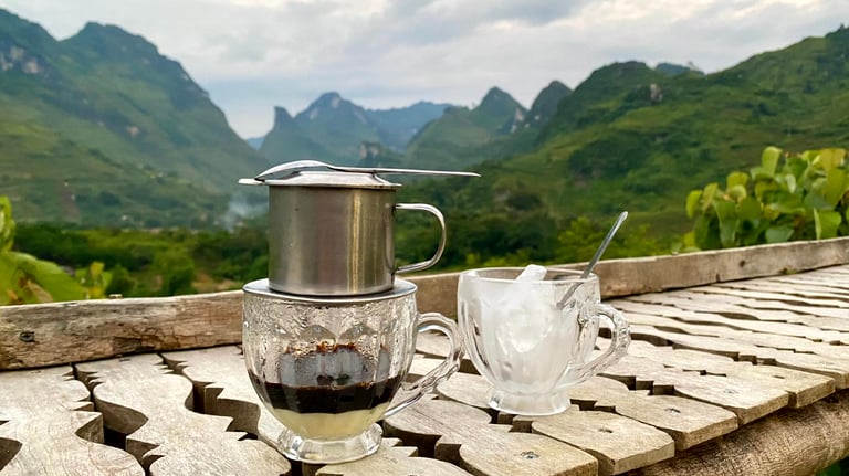 a coffee potted on a table with a cup of coffee