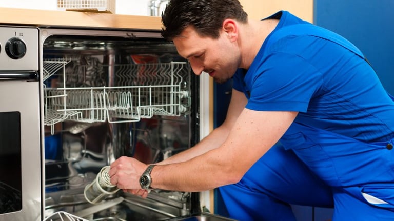 technician is cleaning the filter of a dishwasher
