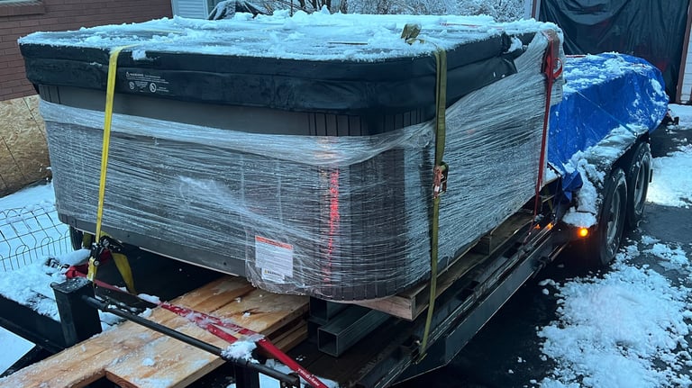 A trailer loaded with a hot tub and lumber for delivery 