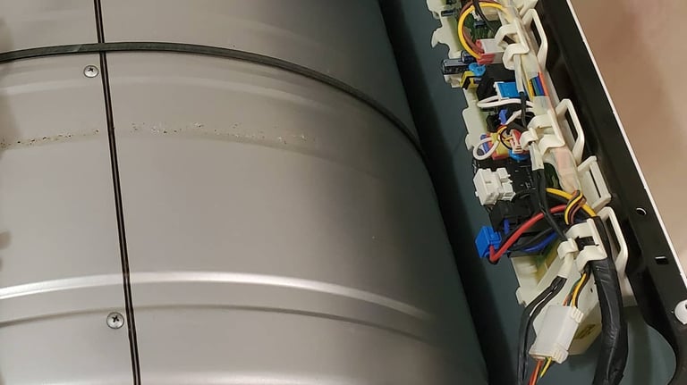 Opened dryer top revealing visible control board for repair.