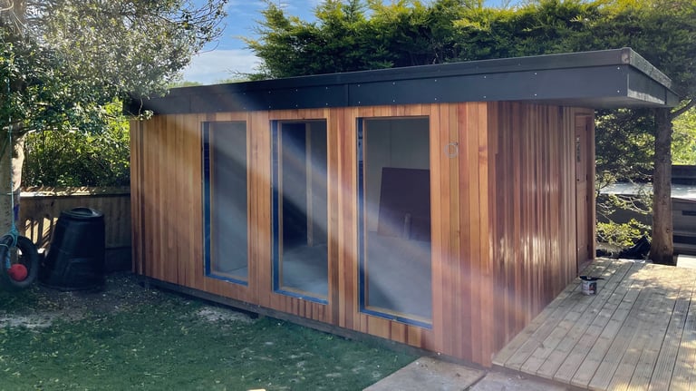 A modern garden studio clad in cedar wood