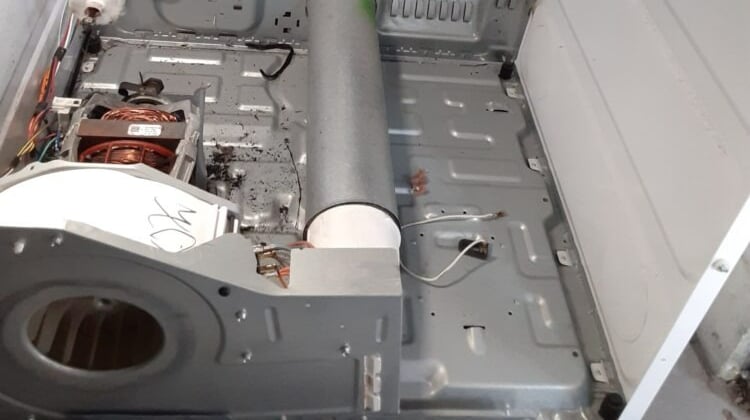 dryer taken a part and showing an exposed heating element