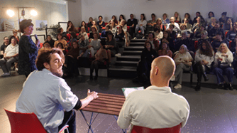 de dos deux hommes assis côte à côte avec public en face forum handicap et emploi