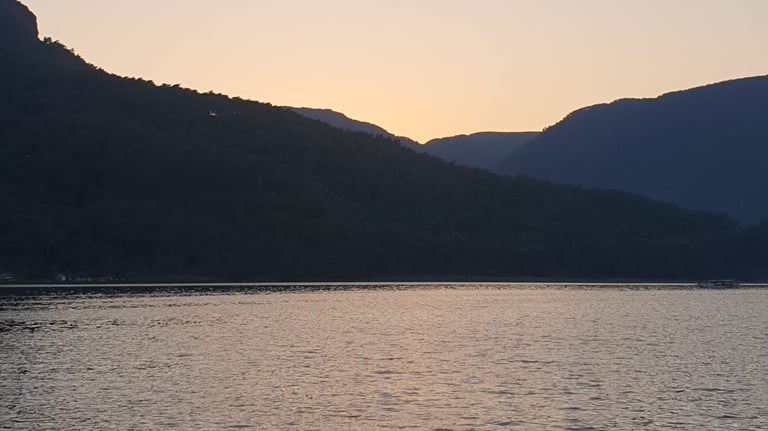 a boat is sailing on the water at sunset