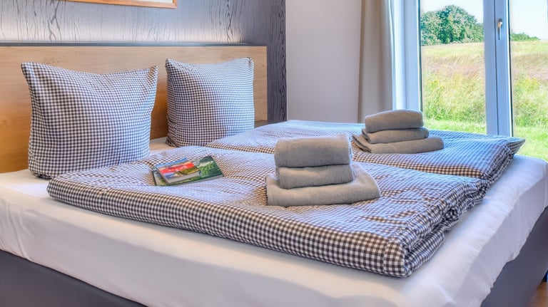 Schlafzimmer mit Doppelbett und Blick ins Grüne