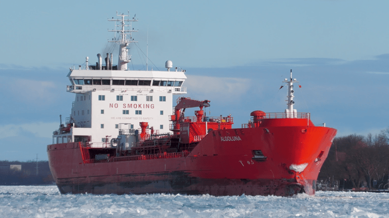 A view of tanker ship Algoluna from the front right side, looking aft. The ship is surrounded by ice covered water.