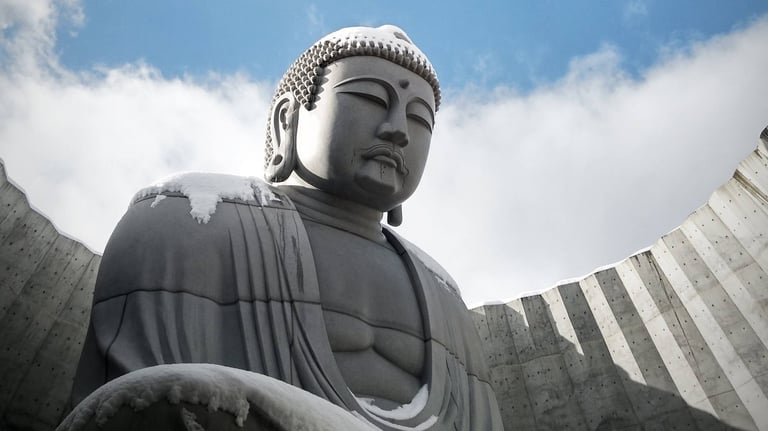 a concrete buddha statue sitting in a circular hole