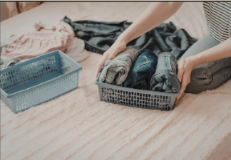 folded clothing organized into storage bin using simple sorting system