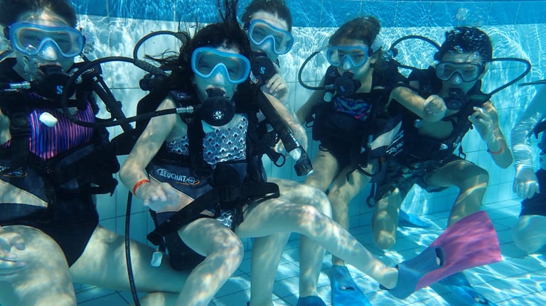 a group of scuba divers in a pool
