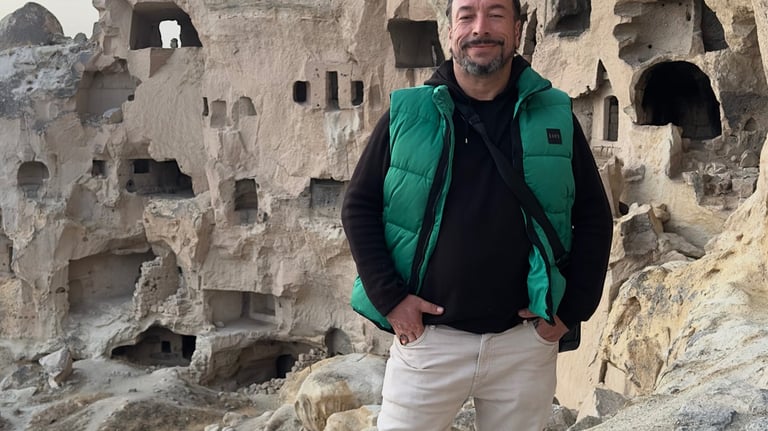 a man standing on a rock formation in a cave