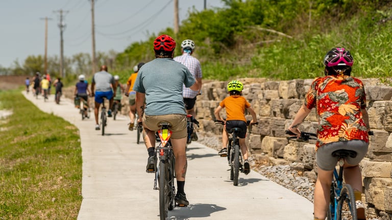 Photo from the back of the line of bikers of all ages