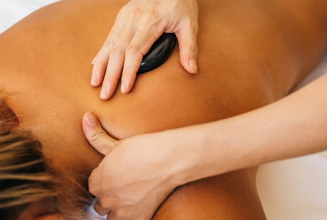 a woman getting a hot stone massage
