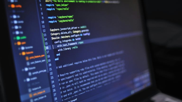 Lifestyle image of laptop computer screen with green, yellow and blue text on it.