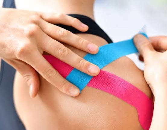 Kinesiology taping for sports injury recovery by physiotherapist