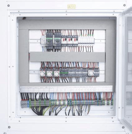 A large electrical cabinet of blast freezer with many wires and wires