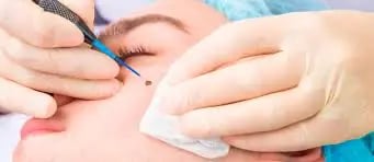 a woman is getting her eyebrows done by a professional hairdrewhich