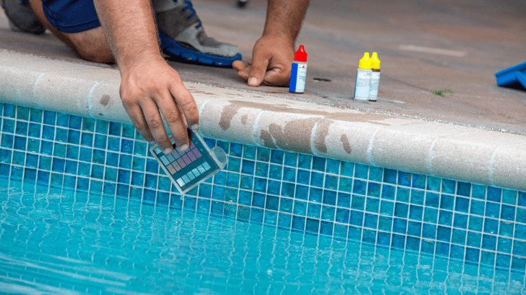 A pool tech is using chemical testing kit to test the PH balance and alkalinity