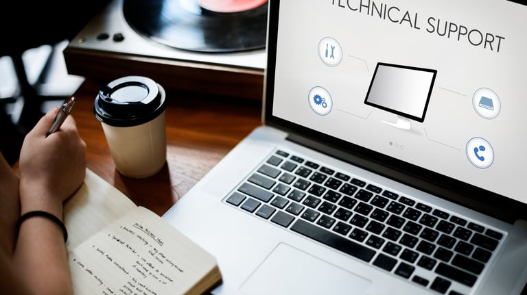 a person holding a notebook and a notebook with a laptop on it