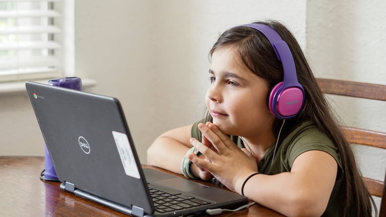 a girl with headphones on a computer