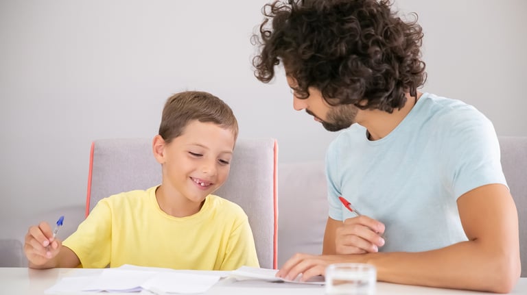 <a href="https://www.freepik.com/free-photo/happy-boy-his-dad-doing-school-home-task-together-writin