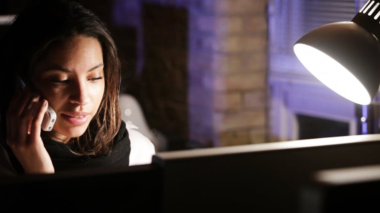 Woman receiving private spiritual guidance and confidential support during a nighttime consultation