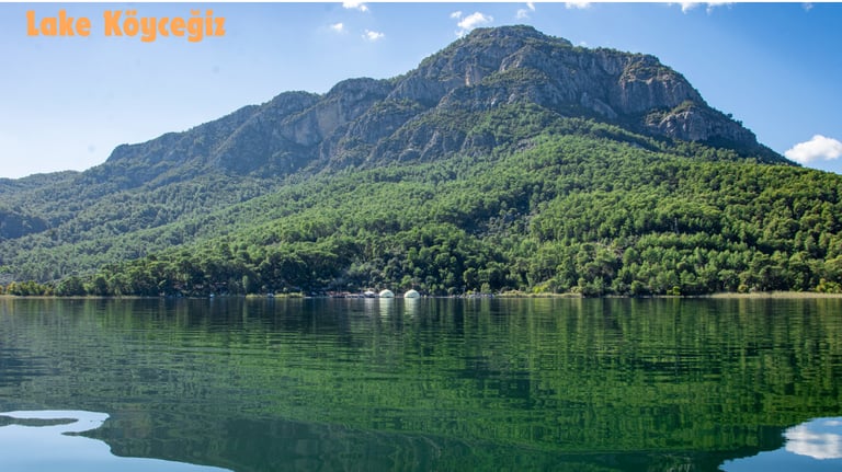 a mountain scene with a lake and a boat