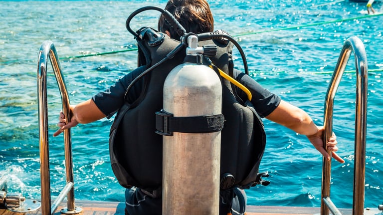 a man in a diving suit is standing on a boat