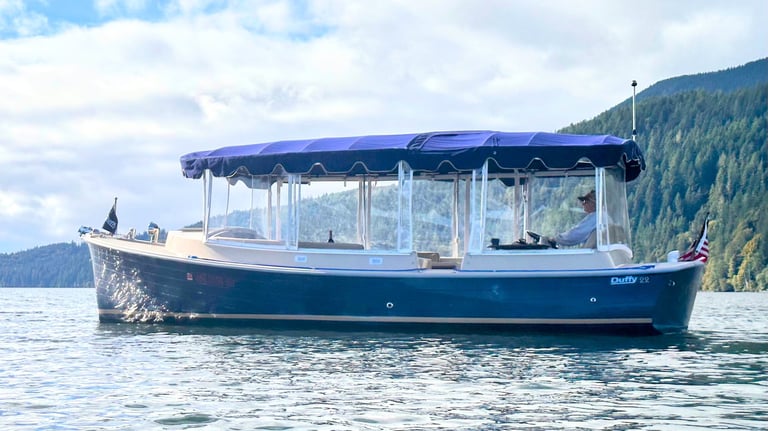 an eco-friendly boat with a blue canopy over it on Quilcene Bay